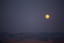 Majestic View Of Full Moon Over Desert