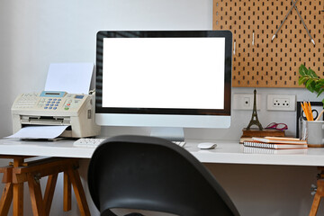 Poster - Comfortable home office interior with blank screen computer monitor, books, potted plant and stationery.