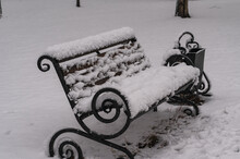 A Bench In The Snow In The Park