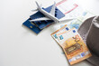 © Angelov - Toy airplane and passport with tickets on white background, top view
