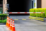 Fototapeta Desenie - security system for building access - barrier gate stop with toll booth, traffic cones and cctv