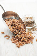 Wall Mural - Green lentil fusilli pasta on a wooden background.