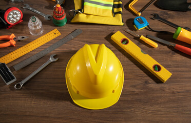 Wall Mural - Work tools with helmet on wooden background.