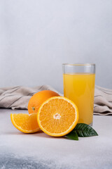 Wall Mural - Glass of fresh juice and ripe orange