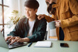 © NINENII - Photo of cute cheerful young couple using laptop and analyzing their finances with documents.