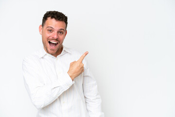 Wall Mural - Young caucasian handsome man isolated on white background surprised and pointing side