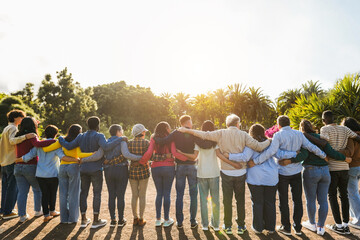 group of multigenerational people hugging each others - support, multiracial and diversity concept -