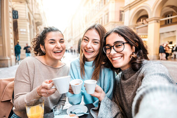 girls friends group drinking cappuccino at coffee bar - women people talking and having fun together
