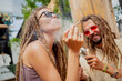 © romaset - Hippie style couple smoking cigarettes with medical marijuana