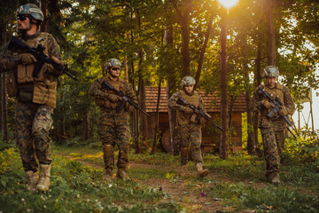 Wall Mural - A group of modern warfare soldiers is fighting a war in dangerous remote forest areas. A group of soldiers is fighting on the enemy line with modern weapons. The concept of warfare and military