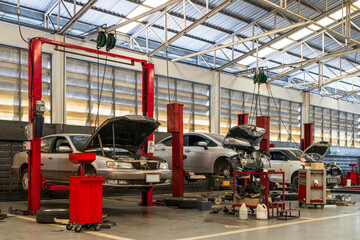 Wall Mural - car repair in garage service station with soft-focus and over light in the background