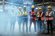 © eakgrungenerd - Group of various nationalities engineer professional successful team corporate workers standing in factory with smoke. teamwork technician inspector manufacturing industry workplace.