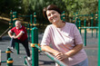 © caftor - Portrait of an mature woman in sportswear on a sports ground in city park