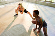 © Flamingo Images - Women exercising on a gym floor