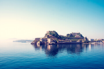 Wall Mural - view of the fortress of corfu from the sea in the morning mist with a steamer in the distance, greec