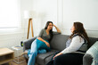 © AntonioDiaz - Happy women friends chatting sitting on the couch