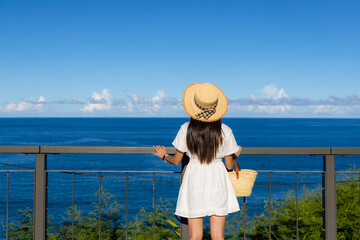 Sticker - Woman with white dress and enjoy the sea view with blue sky