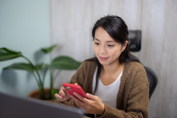 Wall Mural - Woman work on laptop computer with cellphone at home office