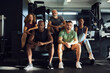 © Flamingo Images - Fit people sitting on steps in a gym