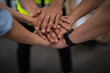 © Jirus - Close up view of warehouse workers putting their hands together. Stack of hands. Unity and teamwork.