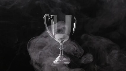 Wall Mural - silver trophy turn around competition in the dark on the black background with smoke, spectacular su