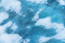 Azure Ice On Turquoise Water Of Lake