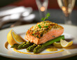 Salmon baked with pistachio crust served on a plate on a bed of green steamed asparagus and hollandaise sauce. Restaurant table setting