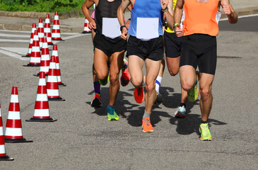 Wall Mural - runners during the marathon on the city streets run in sneakers