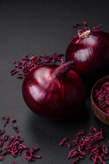 Fresh raw red onion on dark textured concrete background