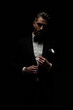 © Viorel Sima - stylish elegant man adjusting and unbuttoning black tuxedo