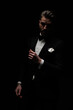 © Viorel Sima - mysterious elegant man wearing black tuxedo and confidently posing