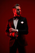 © Viorel Sima - elegant bearded man wearing black tuxedo, looking to side and fixing sleeves