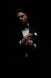© Viorel Sima - stylish unshaved groom in tuxedo touching fingers and posing