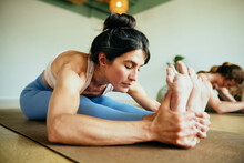 Woman In The Forward Bend Pose During Yoga