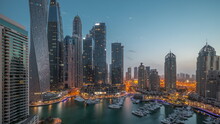 Dubai Marina Tallest Skyscrapers And Yachts In Harbor Aerial Night To Day Timelapse.