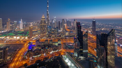 Wall Mural - Aerial view of tallest towers in Dubai Downtown skyline and highway day to night timelapse.