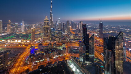 Canvas Print - Aerial view of tallest towers in Dubai Downtown skyline and highway day to night timelapse.