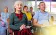 © JackF - Focused motivated older woman listening to lecture in auditorium with group. Seniors education concept