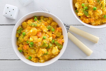 Wall Mural - Charquican, a traditional Chilean dish, vegetarian version, made of lightly mashed and mixed potatoes, pumpkin, onion, carrots, peas, corn and green beans (Selective Focus)