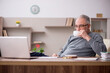 © Elnur - Old male employee working from home during pandemic