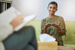 © Lune/peopleimages.com - Therapy, psychology and young woman talking of help, support or mental health solution and therapist writing notes. Counseling service, progress and psychologist with indian patient, client or person