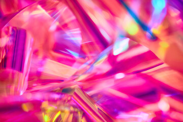 close-up of ethereal bright neon pink, magenta, orange, blue, purple holographic metallic foil backg