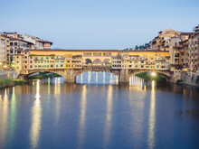 Ponte Vecchio Over Arno River In City Against Sky At Dusk