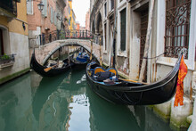 Gondolas In Narrow Canal By Buildings