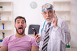 © Elnur - Young male patient visiting old male doctor otologist