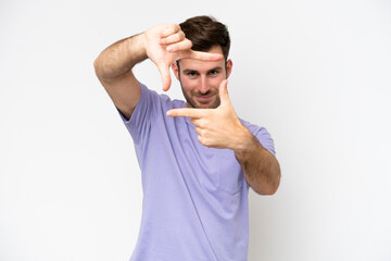 Wall Mural - Young caucasian man isolated on white background focusing face. Framing symbol