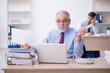 © Elnur - Two male colleagues working in the office