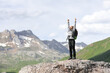 © Antonioguillem - Excited hiker celebrating vacation raising arms in nature