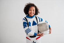 Smiling Girl Wearing Space Suit Standing In Front Of White Wall