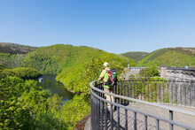 Germany, North Rhine Westphalia, Senior Hiker Looking Toward Rursee Lake From Viewing Platform